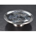 An Edwardian Britannia silver tazza or pedestal visiting card tray, of circular form with moulded