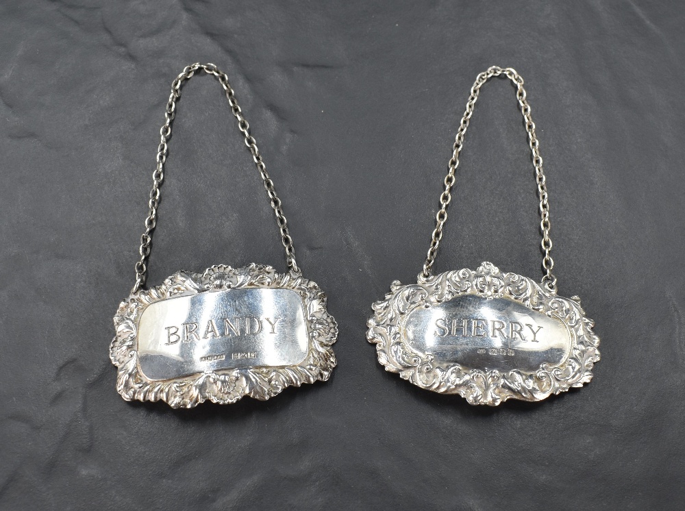 Two Elizabeth II silver spirit labels, of traditional design named Sherry & Brandy, marks for London