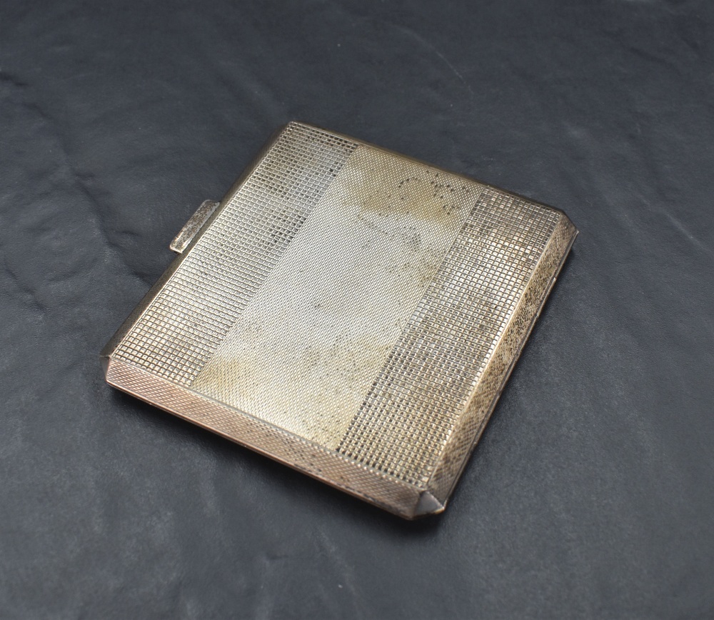 A George V silver cigarette case, of hinged and canted square form with engine-turned decoration,
