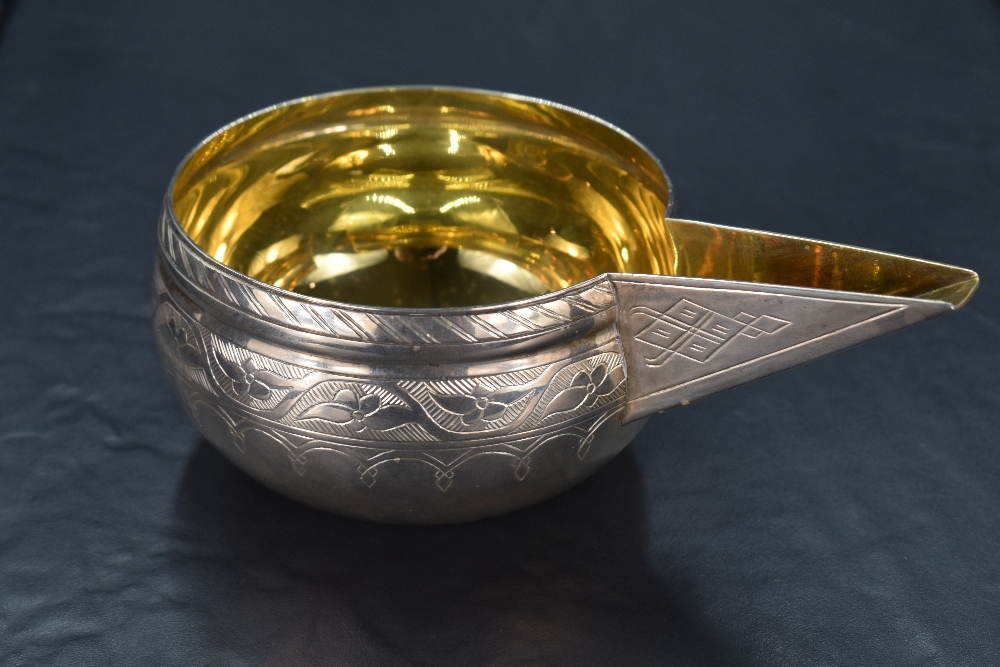 An unusual Elizabeth II silver vessel of globular form with substantial angled spout, decorated with