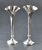 A pair of Edwardian silver spill vases, of flared and ruffled form with fine bead moulding to the