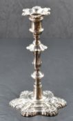 A George II cast-silver candlestick, of traditional knopped design with moulded scallop, fluted