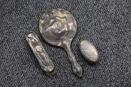 A George V silver backed brush set, comprising a hand mirror and clothes brush, sold along with a