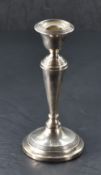 A George V silver candlestick, of traditional design with reeded decoration, marks for Birmingham