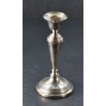 A George V silver candlestick, of traditional design with reeded decoration, marks for Birmingham