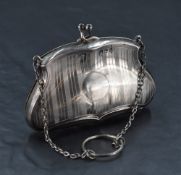 A George V silver purse, of shaped form with engine-turned decoration and sectioned leather