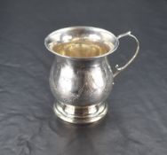 A George V silver christening cup, of baluster form engraved with swags, ribbons and pendants,