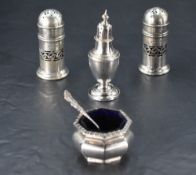 A pair of George V silver pepperettes, of cylindrical form with central pierced band and pierced