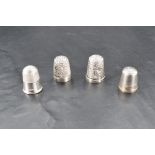 A group of four silver thimbles, Birmingham 1900, 1906, Chester 1893 & Sheffield 1979, 12.7grams