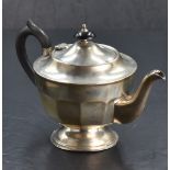 A 1930's silver teapot, of half-fluted circular form raised on a circular foot, marks for