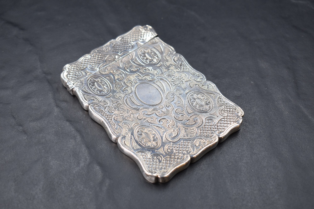 A Victorian silver visiting card case, of shaped and hinged rectangular form, engraved throughout - Image 2 of 2