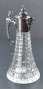 An Elizabeth II silver mounted cut-crystal claret jug, having hinged, domed and finial topped