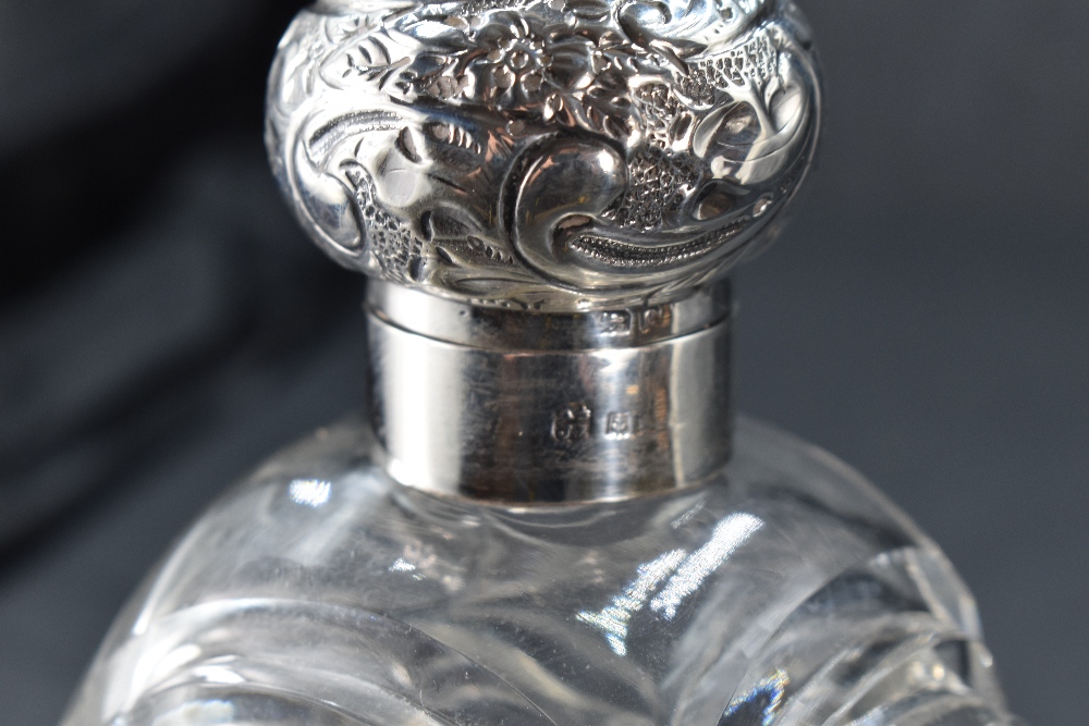 A large silver-mounted cut-glass scent bottle, having a foliate embossed and hinged cover over the - Image 2 of 3