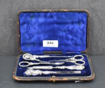A late Victorian silver-mounted manicure set, having typical embossed scroll decoration, marks for