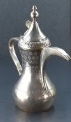 An unusual Elizabeth II silver dallah coffee pot, of traditional design with substantial strap