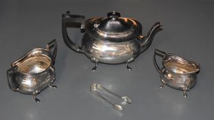 A matched George V silver four-piece teaset, comprising teapot, sugar and cream, of rounded