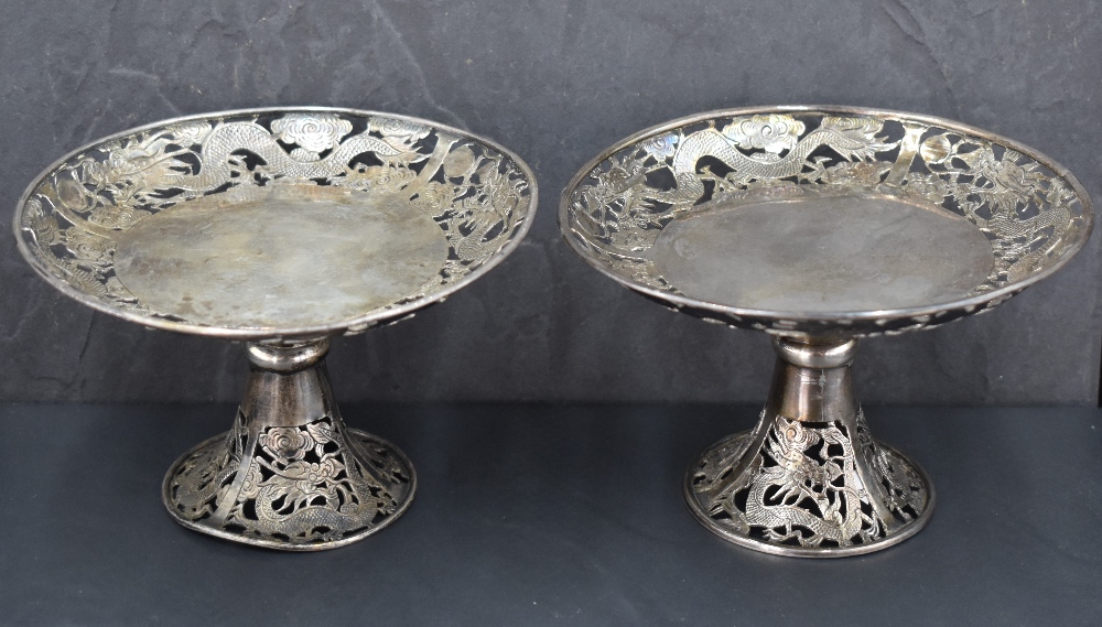A pair of late 19th/early 20th century Chinese white metal pedestal dishes, of circular form