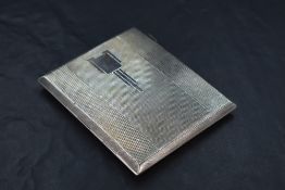 A 1930's Art Deco silver cigarette case, of hinged rectangular form engine-turned throughout and
