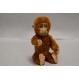 An early 20th century German Schuco monkey perfume or scent bottle having piccolo brown mohair