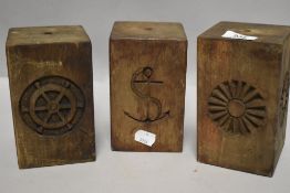 Three teak wood carved wooden blocks with nautical sailing theme designs.