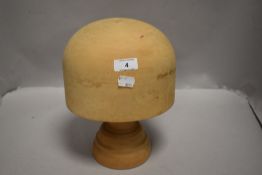 A modern turned Beech wood hat stretcher or Milliners block
