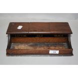 An Edwardian desk top ink well in oak having compartments for Red, Black and Blue.