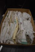 A box full of vintage and antique table linen including embroidered examples, tray and table