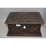 An antique sewing case or jewellery box having a naturalistic carved and poker worked case