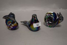 Three modern iridescent glass paper weights in the form of a rabbit, bird and snail.