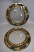 A pair of nautical ships portholes having heavy brass cast frames each measuring 30cm across.