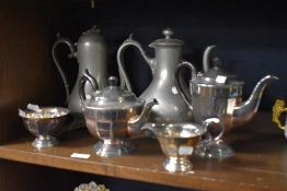 A silver plated Edwardian tea set and two large pewter coffee or chocolate pots