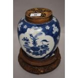 An antique Chinese export ginger jar having both carved lid and stand decorated with two panels of