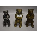 Three early 20th century penny saving money banks in the form of bears.