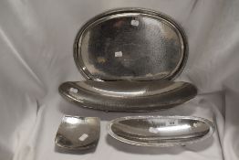Four pieces of Lakeland Rural Industries metal ware including three footed bowls and a serving
