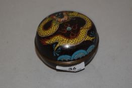 An early 20th century Japanese cloisonne lidded container with a dragon design cover. 8cm across