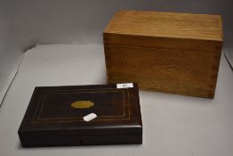 A mahogany cased smokers humidor with a similar golden oak lidded storage box