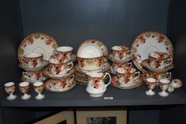 A Victorian part tea service in porcelain unmarked and decorated in brown and green floral