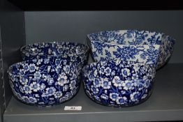 Four vintage ceramic bowls having full chintz floral patterns. One having repair