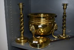 Brass wares including a coal bucket on lion head formed tripod feet, a pair of twist stem candle