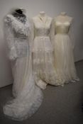 Three vintage 1970s wedding dresses and a veil, various styles, smaller sizes.