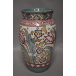 An early 20th century Charlotte Rhead Bursley ware vase decorated with tube lined flowers in a