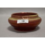 An early 20th century Royal Lancastrian pottery bowl having a red ground and yellow lustre glaze,