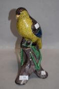 A Meiji period Japanese export porcelain parrot figure perched on naturalistic branch and fungus.