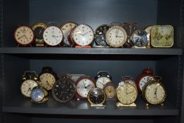 A good collection of approximately twenty five matal cased and similar alarm clocks including