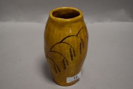 An Arts and Crafts era studio pottery vase hand decorated with Barley sprigs. 16cm tall possibly
