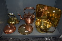 A selection of copper and brass wares including serving tray, jam pan, stove kettle and foot
