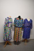 Three brightly patterned 1980s outfits, including silk Diane Fres and Kanga collection.