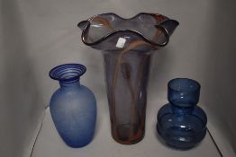 Three modern art glass vases including a large fluted purple and pink steaked vase