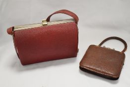 Two early 20th century leather hand bags of stylised design