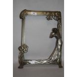 An Art Nouveau picture or mirror frame in an Archibald Knox Liberty style with female figure and